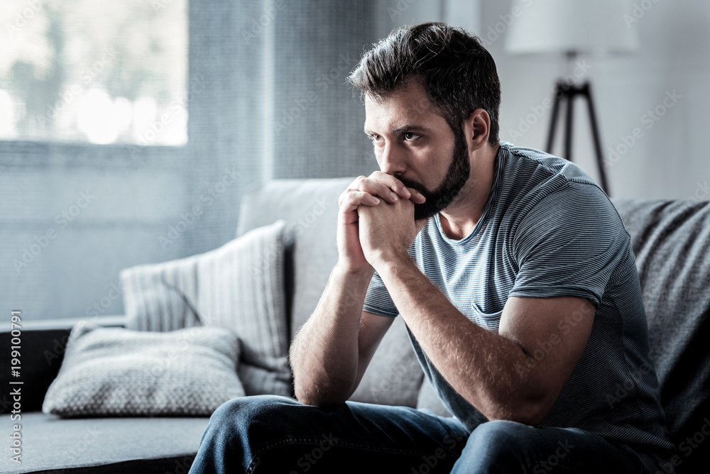 Person sitting quietly with a thoughtful, tired expression, symbolizing chronic stress and a mind that cannot fully relax.
