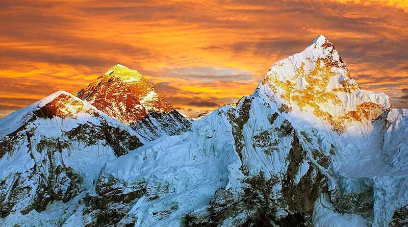 Everest in Transformation — sunset view of Mount Everest with glowing peaks and snow‑covered ridges.