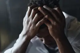 Why People Suffer shown through two hands offering comfort and human connection.