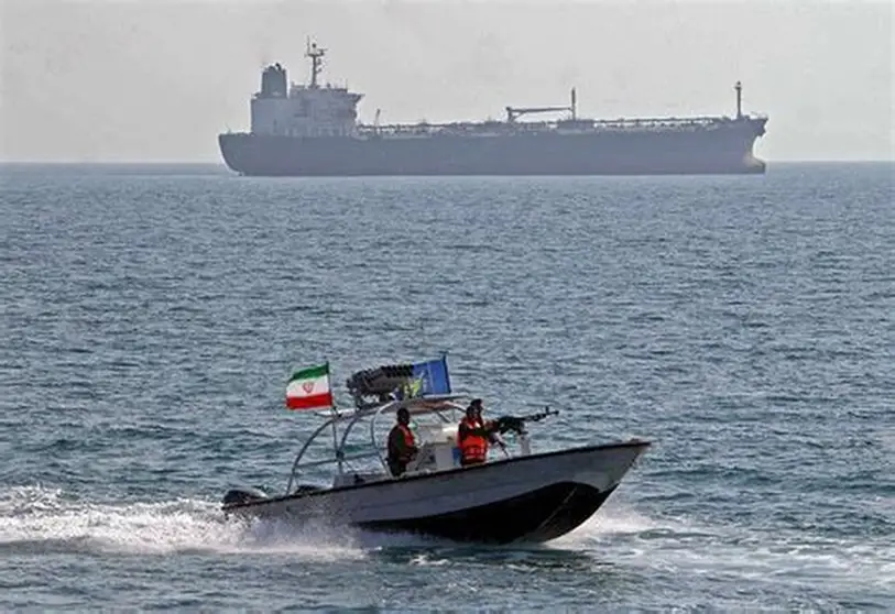 A military ship and a fast patrol boat moving across open waters during maritime operations.