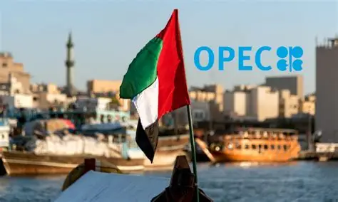 UAE flag displayed near traditional wooden boats on a waterfront, with the OPEC logo in the background symbolizing the country’s departure from the oil alliance