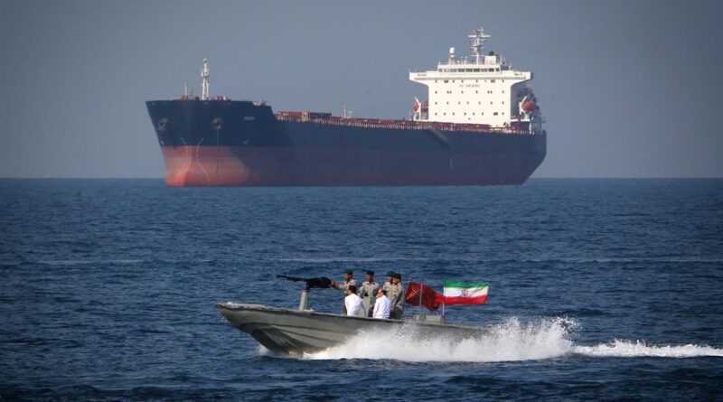 Cargo ships navigating through the Strait of Hormuz amid heightened regional tensions