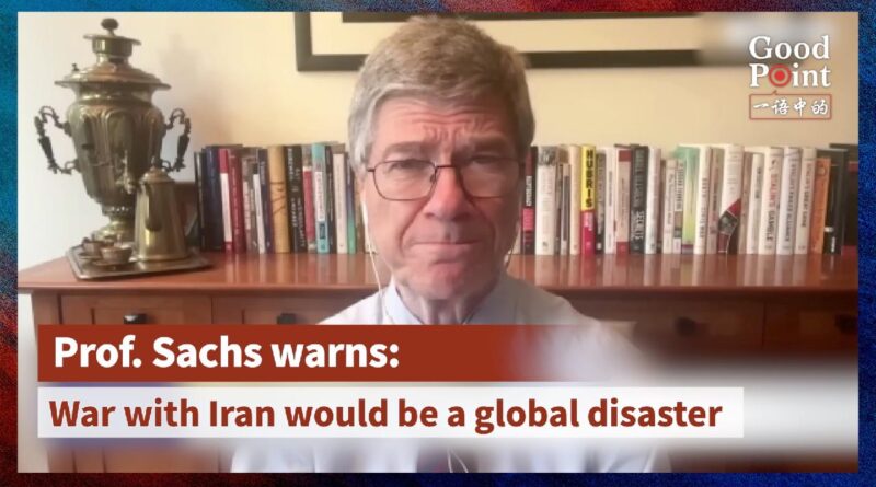 Professor Jeffrey Sachs speaking in a video interview, seated in front of a bookshelf with a samovar, warning about the global risks of a potential war with Iran