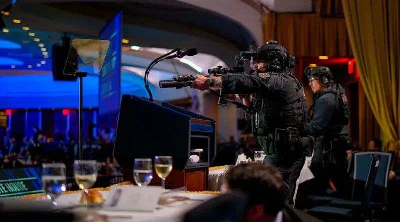 Two armed tactical officers inside a large indoor hall aim their rifles while searching for a suspect, standing alert in a tense security operation.