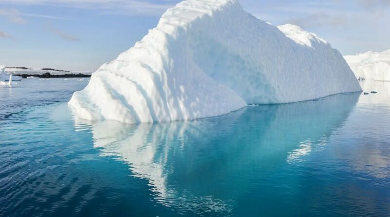 Greenland Ice Sheet Collapse illustrated by a massive iceberg floating in Arctic waters