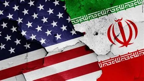 “Split image of the United States and Iranian flags with a cracked divide symbolizing rising geopolitical tensions between the two nations.