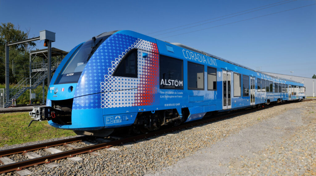 Alstom Coradia iLint hydrogen train during its first circulation in France, running on open tracks with blue livery and H₂ markings.