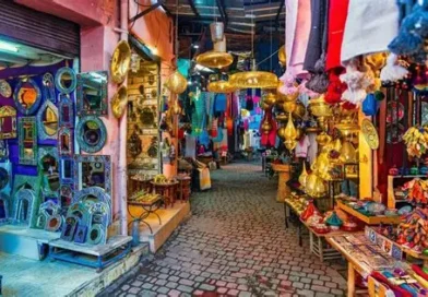 Marrakech and the High Atlas – vibrant souk in The Medina with brass lamps, textiles, and traditional Moroccan craftsmanship.