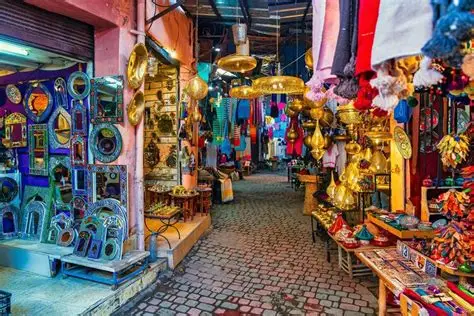 Marrakech and the High Atlas – vibrant souk in The Medina with brass lamps, textiles, and traditional Moroccan craftsmanship.