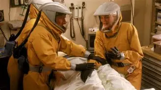 Health workers in full hazmat suits treat a patient during the new Ebola Bundibugyo outbreak declared a global emergency by the WHO.