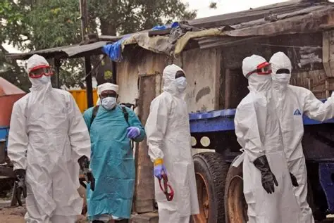 Ebola outbreak Congo health workers in protective suits during disinfection operations