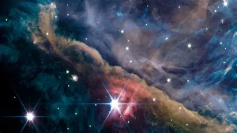 Cosmology updates 2026: bright star illuminating a colorful interstellar nebula with gas, dust and scattered background stars.