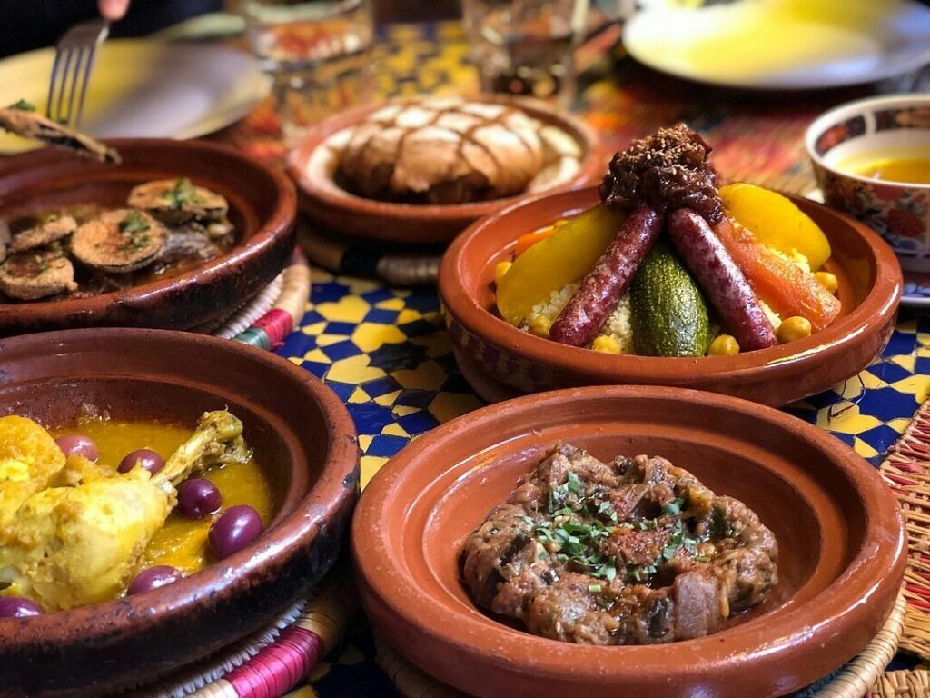 Marrakech and the High Atlas – traditional Moroccan cuisine with colorful tagines, couscous, vegetables, and spices served in The Flavors of Marrakech.