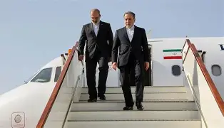 “Iranian officials descending from an aircraft during an official diplomatic arrival.
