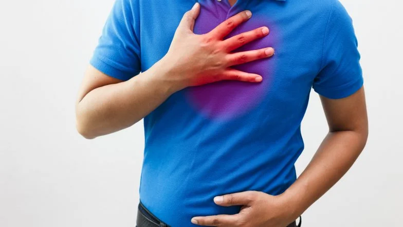 A person holding their chest with a red glowing area, illustrating stress‑related chest discomfort and the physical impact of emotional tension.