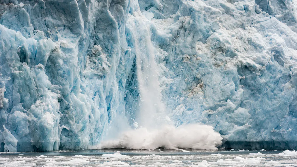 Greenland Ice Sheet Collapse showing glacier calving into the ocean