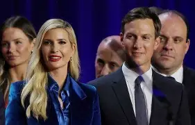 Jared Kushner and Ivanka Trump standing together at a formal event with other attendees in the background.