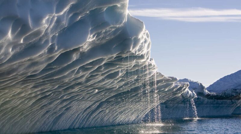 Melting Arctic ice formation with cascading meltwater streams illustrating the physical effects of Arctic Amplification in a warming polar environment.