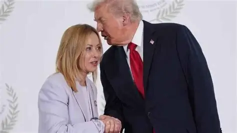 Handshake between two officials during a formal meeting, with one leaning in to speak privately.