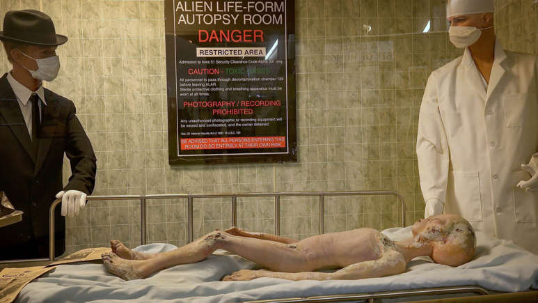 Area 51 alien autopsy exhibit inside a restricted military-themed room