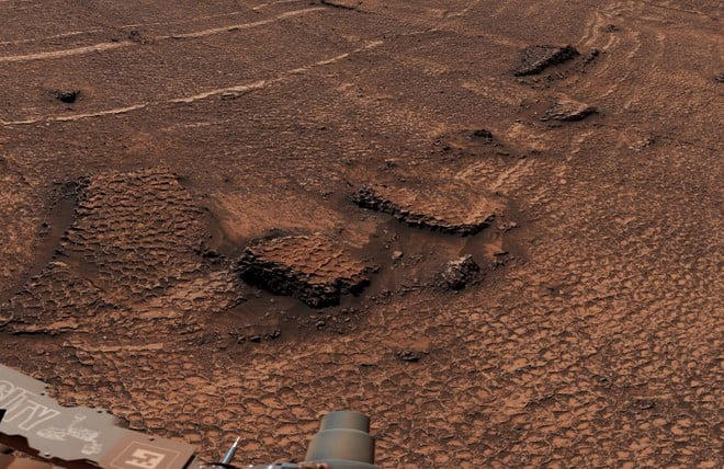 Curiosity honeycomb formations on Mars showing polygonal fractures across a reddish rocky terrain captured by the rover.