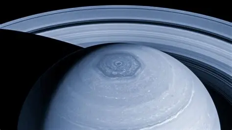 Saturn south pole decagon contrasted with the planet’s northern hexagon and ring system.