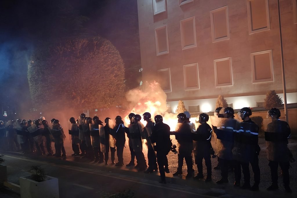 Global Crisis of Trust as police stand in formation during protests and fires in Tirana, Albania